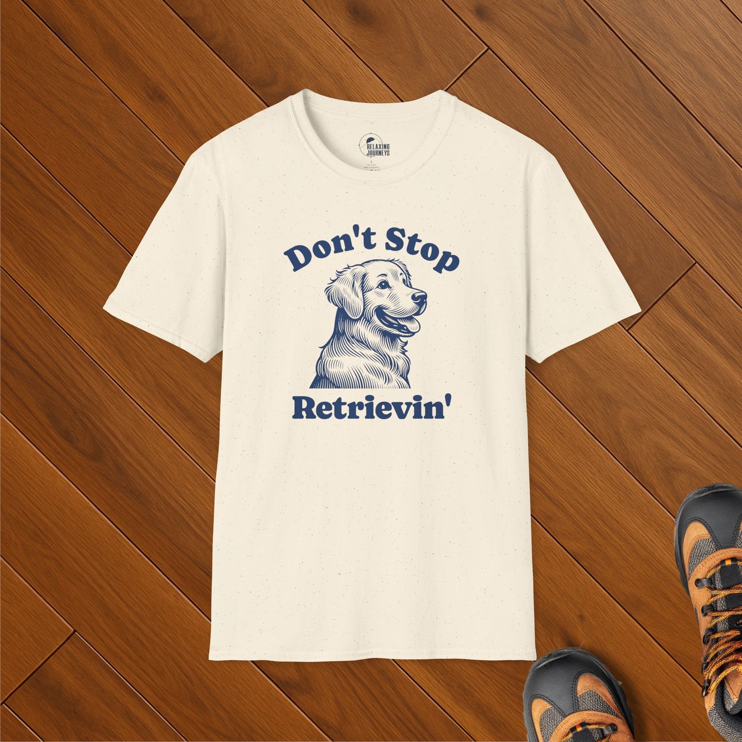 Cream t-shirt with vintage-style illustration of a happy golden retriever and the phrase "Don't Stop Retrievin’" in navy – cute retro dog lover shirt
