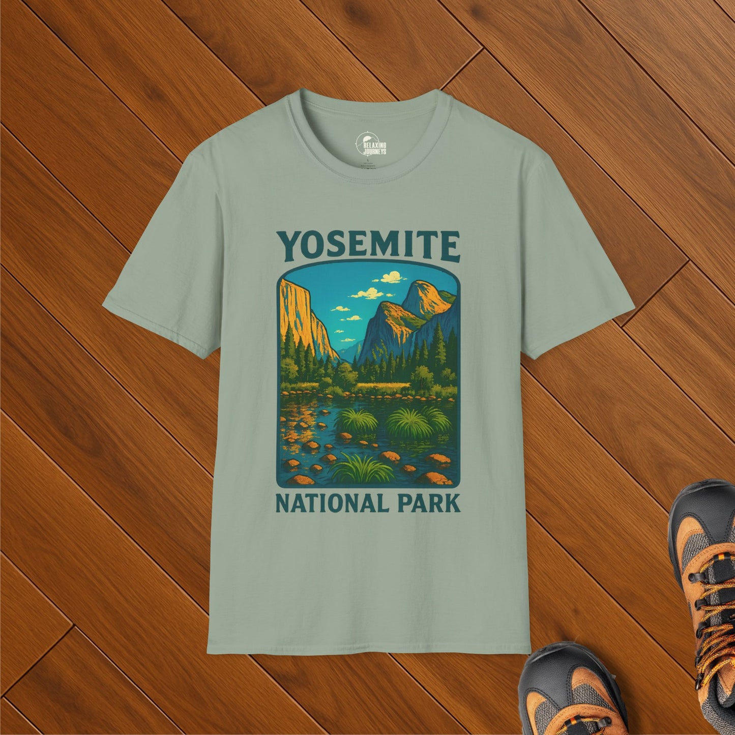 Green t-shirt with colorful illustration of Yosemite National Park including Half Dome, El Capitan, and a scenic valley view with trees and a stream