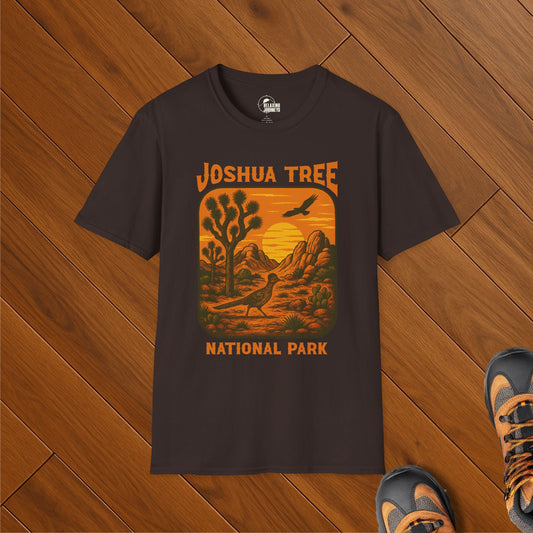 Dark brown t-shirt featuring a vintage sunset illustration of Joshua Tree National Park with a road runner, rock formations, and Joshua trees