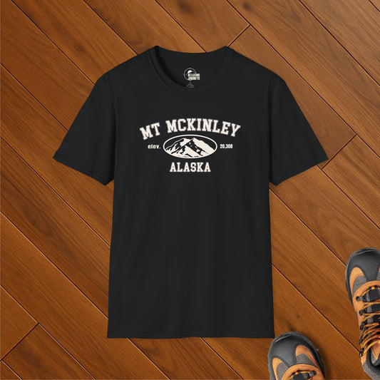 Black t-shirt with white university-style text reading "Mt McKinley Alaska" and a mountain illustration with elevation 20,308 ft