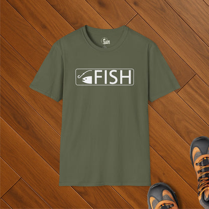 Olive green t-shirt with white FISH text and trail sign fishing hook icon, laid on wood floor with hiking boots